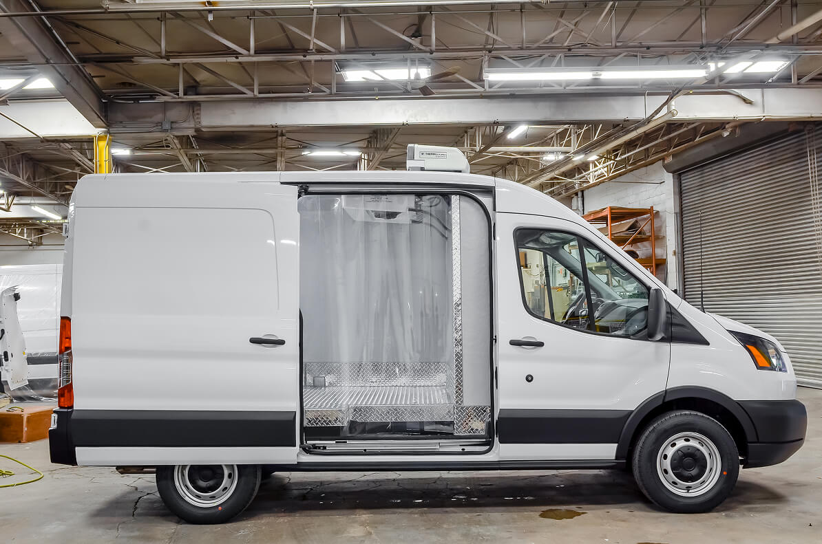 Refrigerated van cargo area with side door open and thermal curtain