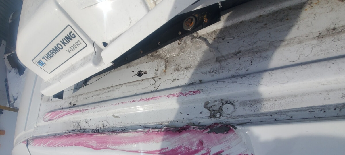 Damaged refrigeration unit components on van roof